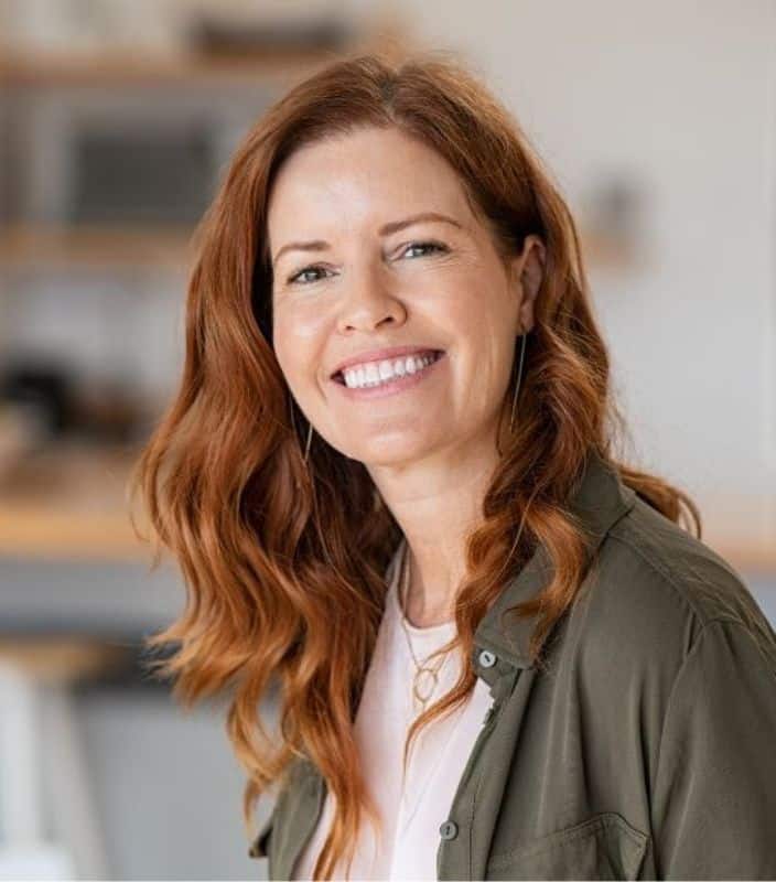 Restorative page content image 1 Adult woman with long, red hair smiling